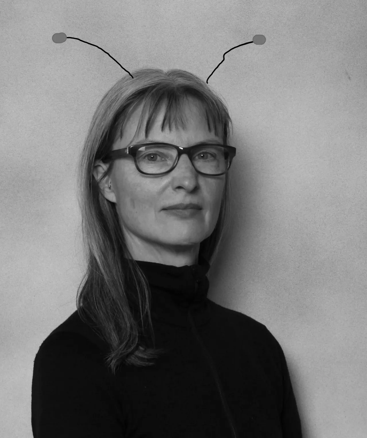 A woman wearing glasses and antennas on her head.
